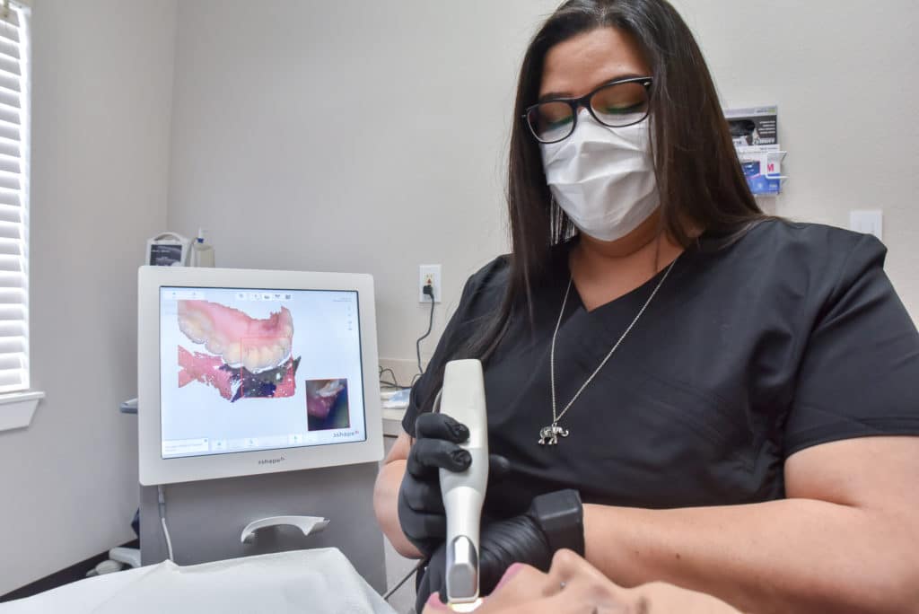 Dental Hygienist putting in a tooth filling