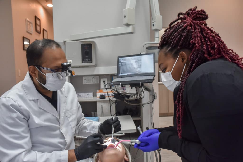our dentist in DeSoto performing a root canal procedure on a patient