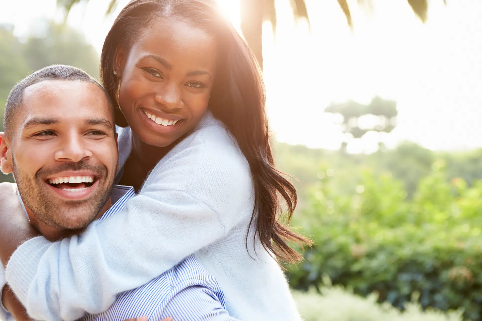 Smiling couple enjoying a sunny day outdoors.